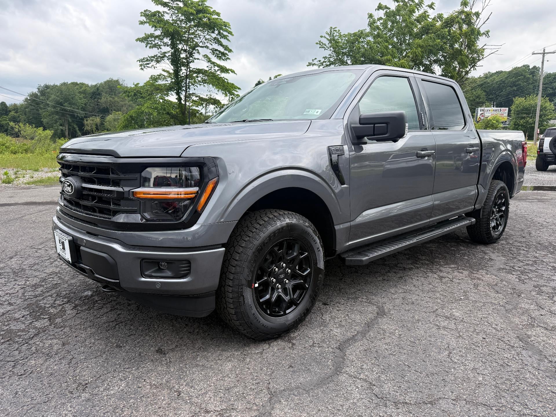2026 Ford F-150 XLT 4WD SuperCrew 5.5' Box in Carbonized Gray Metallic — front three-quarter view