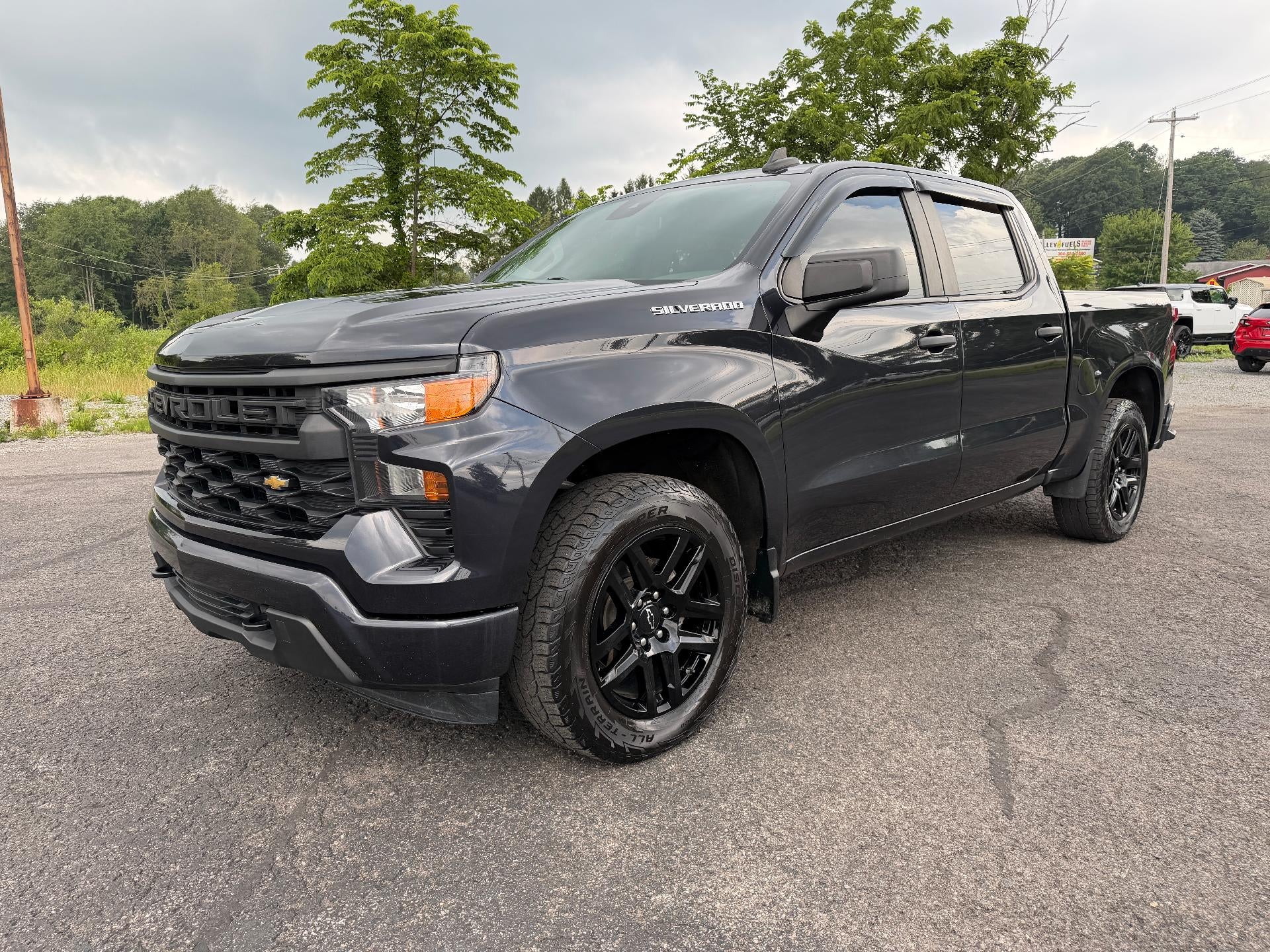 2023 Chevrolet Silverado 1500 Crew Cab Short Box 4-Wheel Drive Custom in Dark Ash Metallic — front three-quarter view